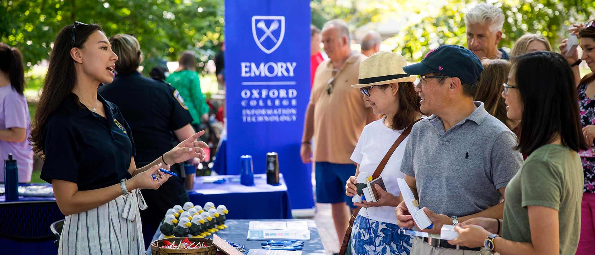 Parents engage with information at Oxford orientation.