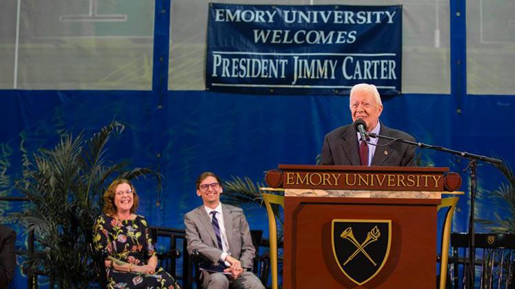 Three presidents, one stage: Emory President Claire E. Sterk and Student Government Association President Ben Palmer join U.S. President Jimmy Carter on the Town Hall stage.