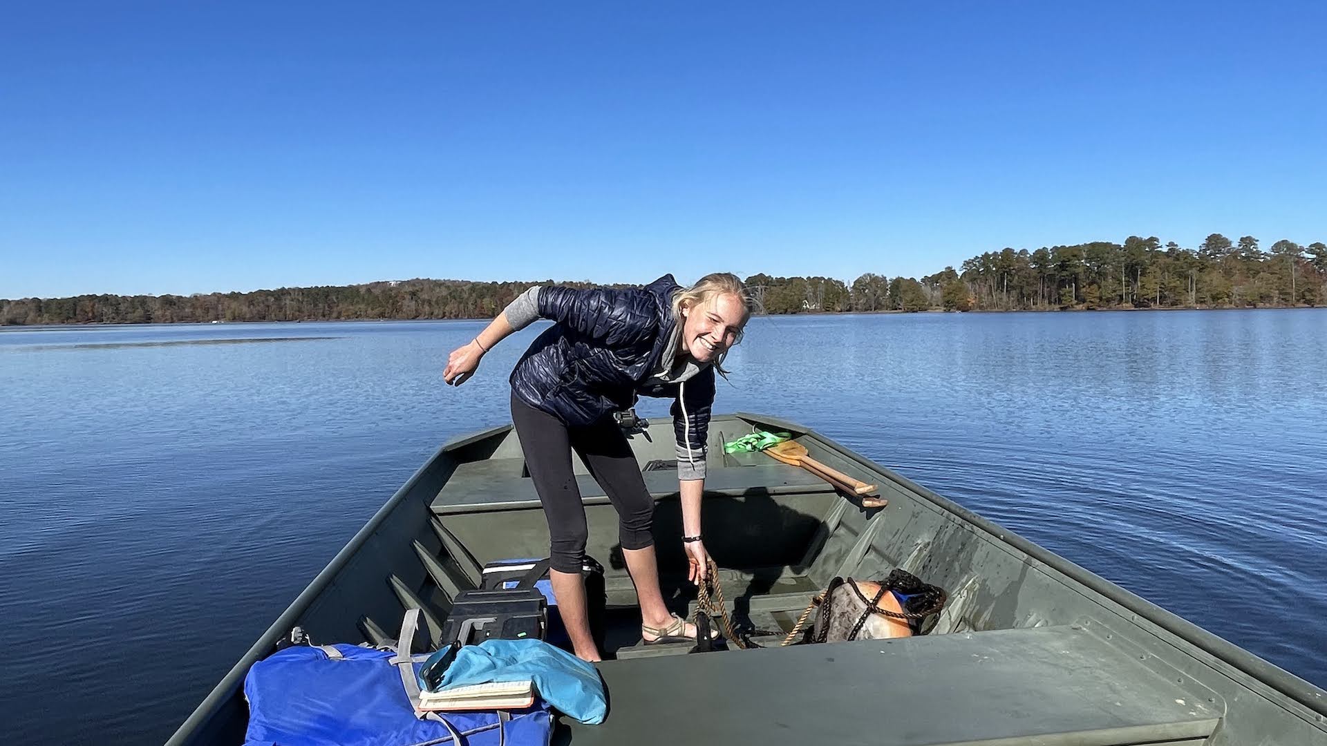 Student researcher on lake