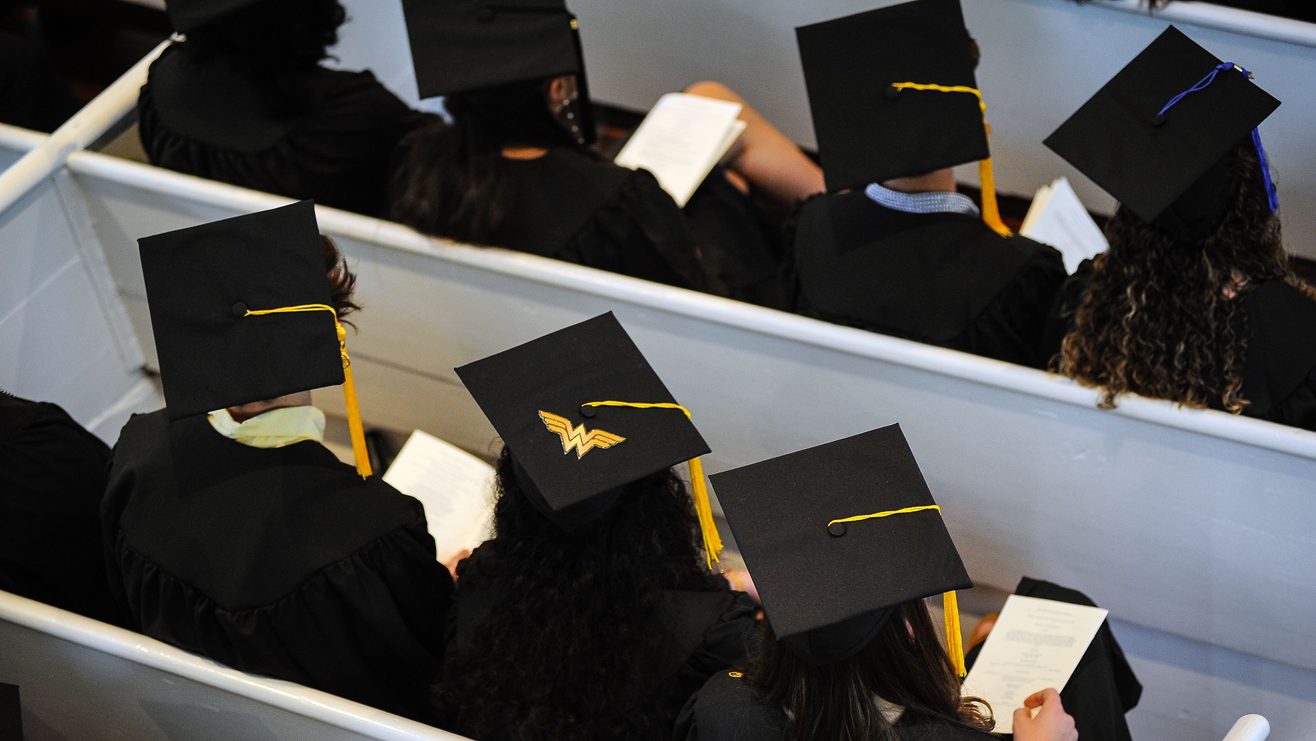 A student sports a Wonder Woman logo on the top of their graduation cap.