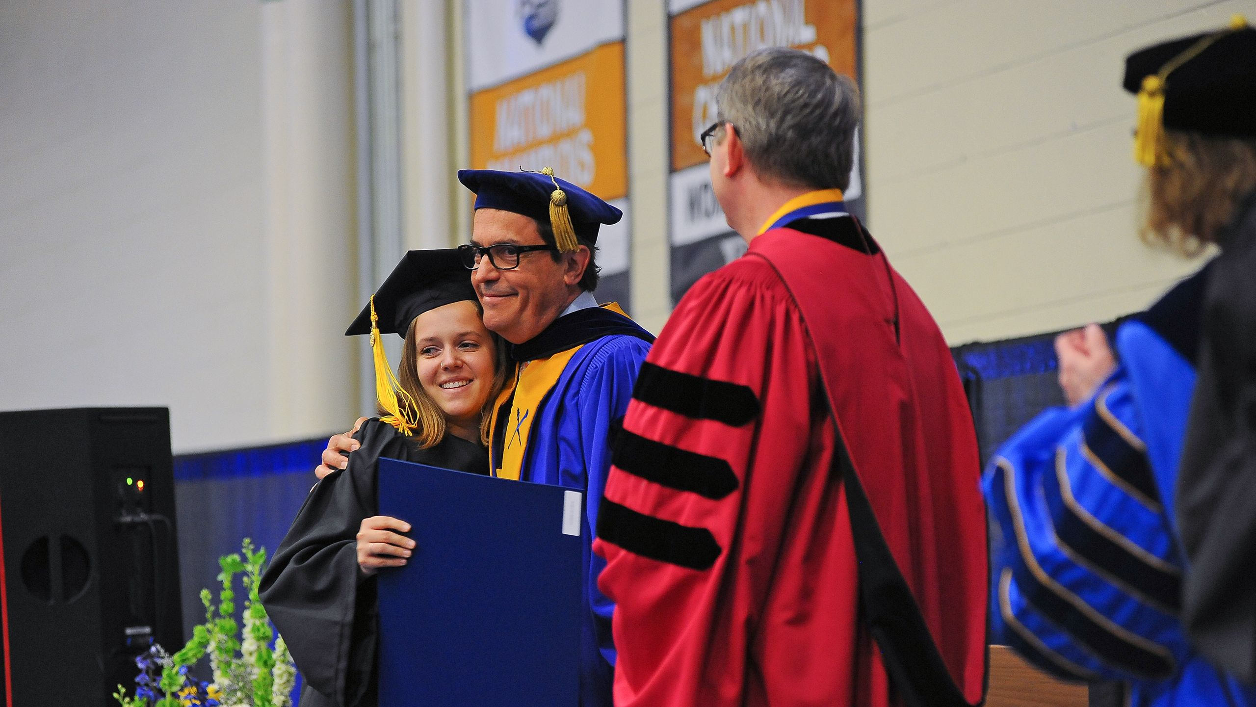 Dean for academic affairs Ken Anderson congratulates a graduate.