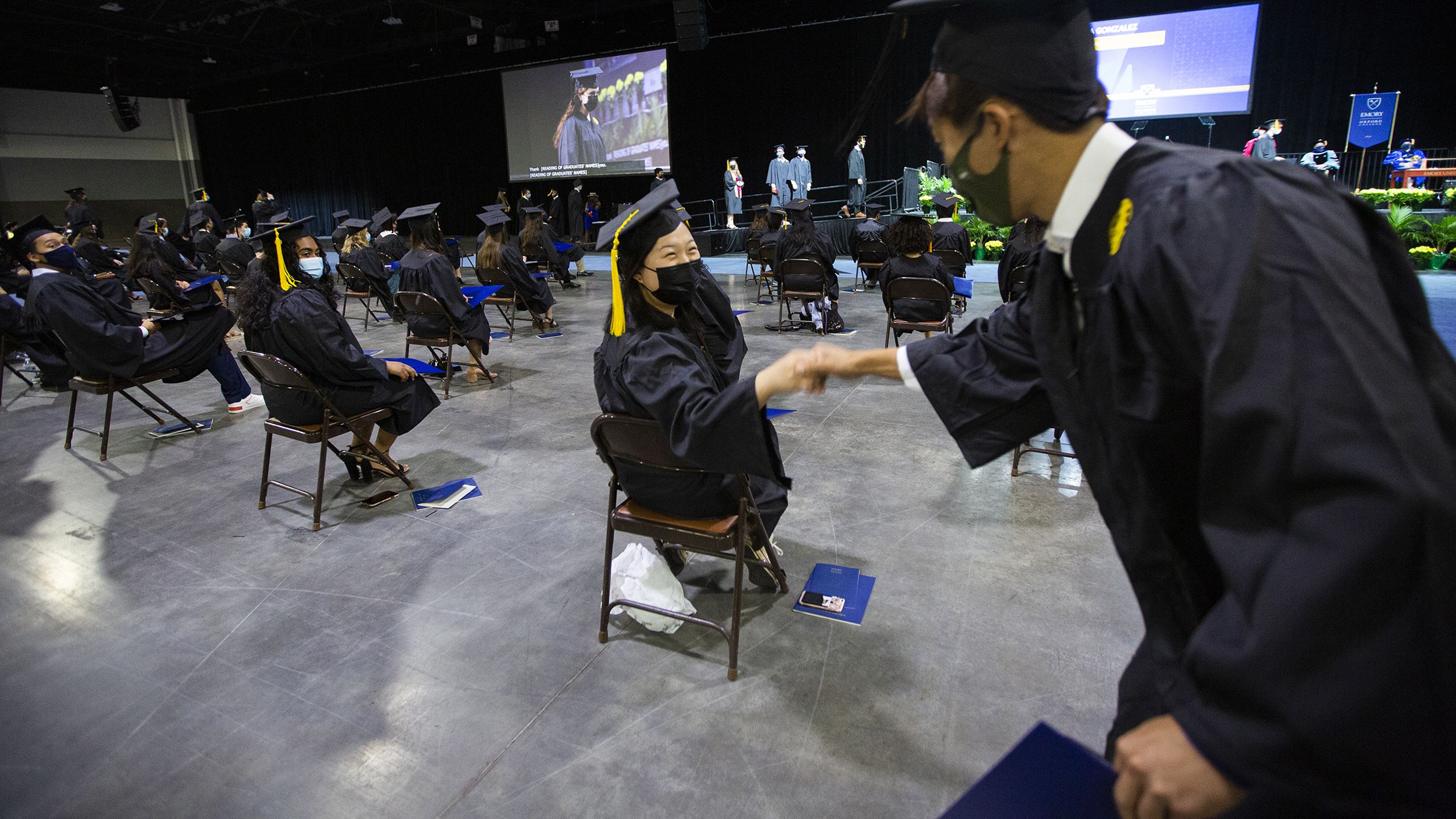 Students do a fist bump during the ceremony.