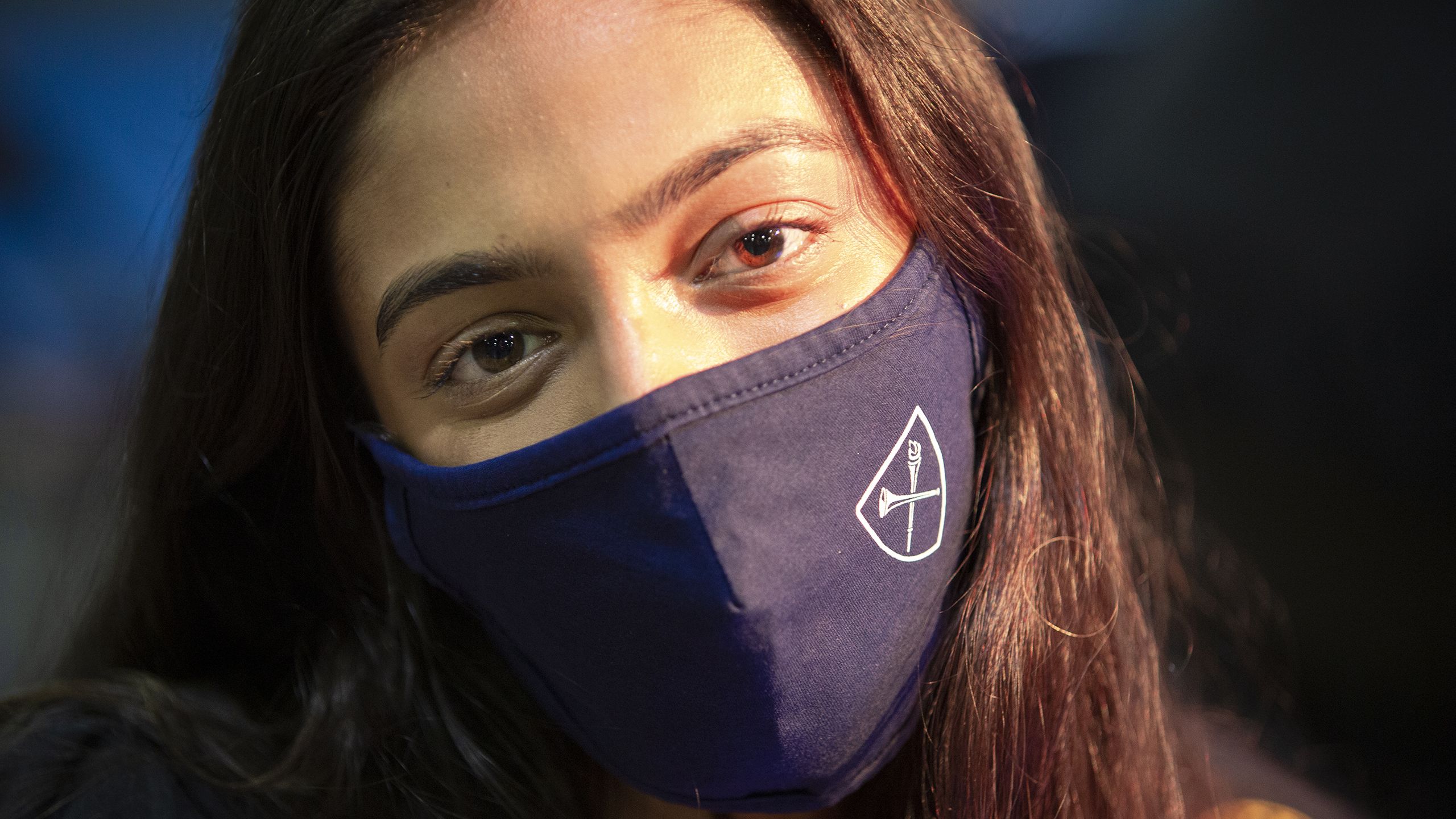 A student wearing an Emory mask during Commencement