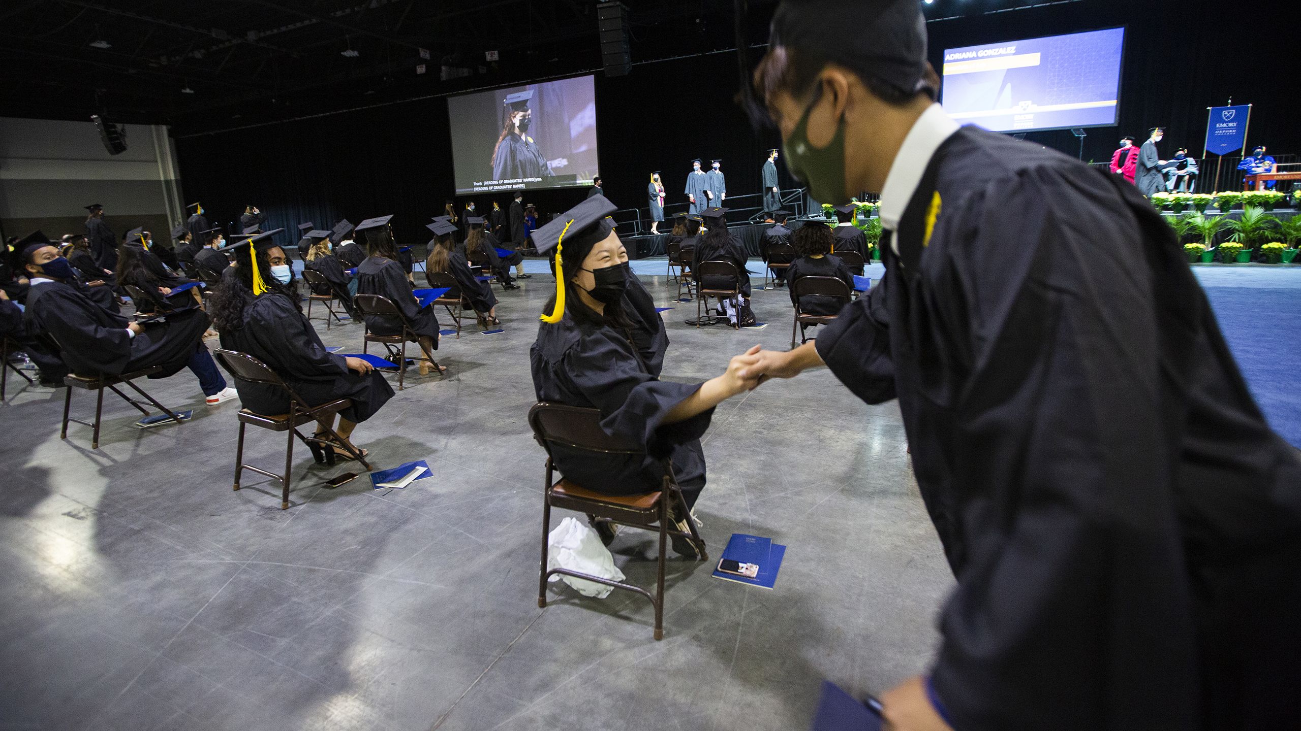 Students offer each other congratulations during the ceremony.