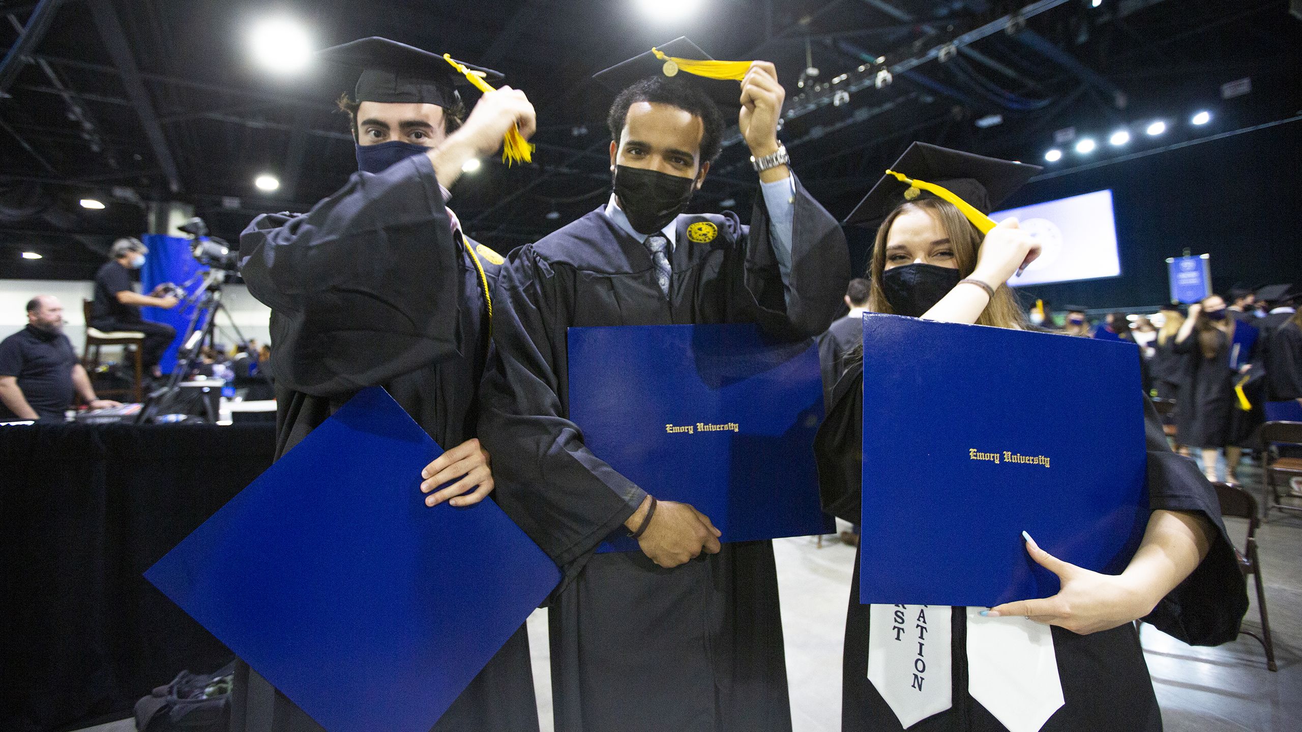 Oxford graduates turn the tassels on their caps after the Commencement ceremony.