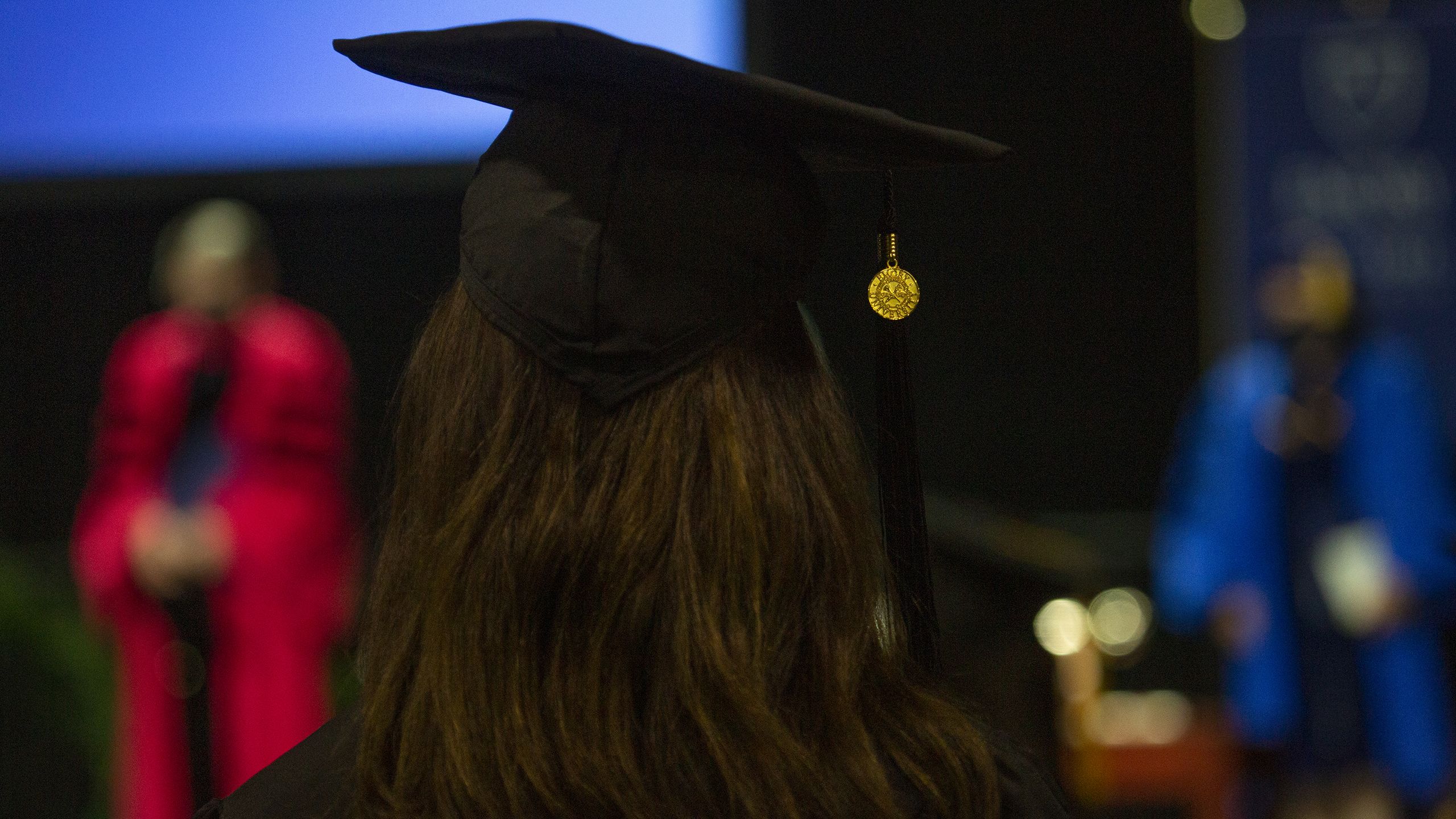 The back of a graduate with their cap