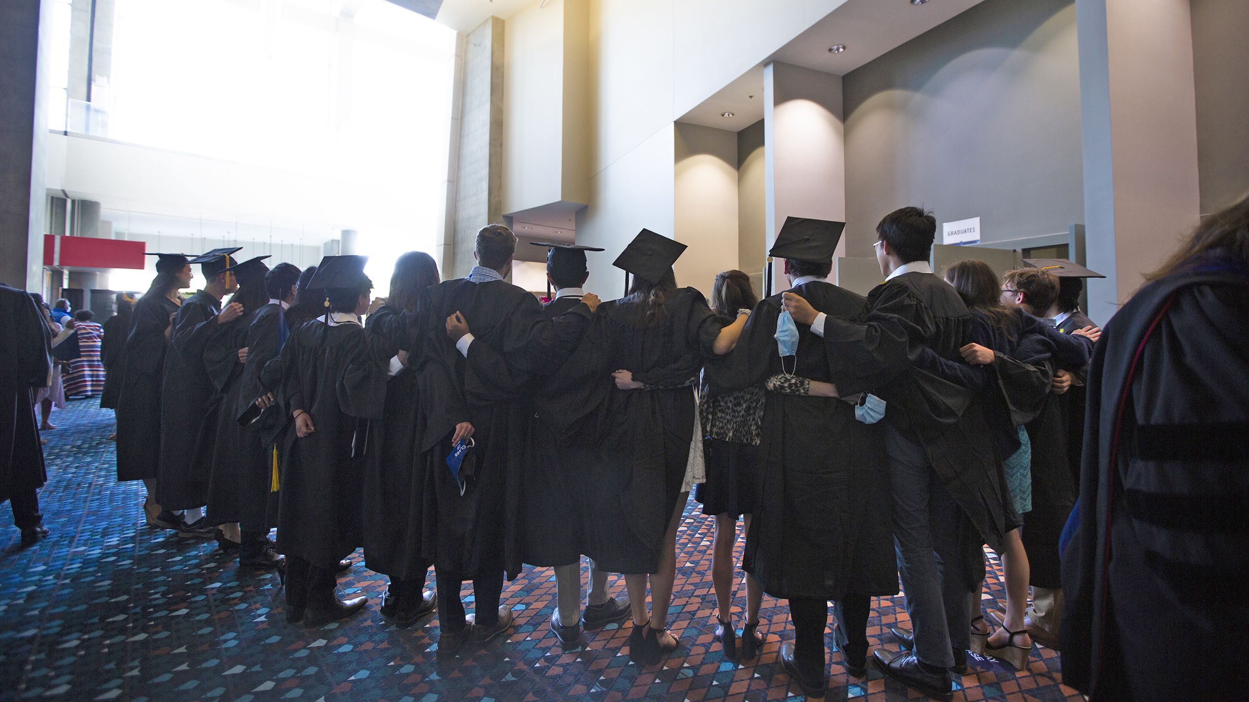 Chaplain Lyn Pace and Dean Douglas Hicks pose with graduates after baccalaureate.