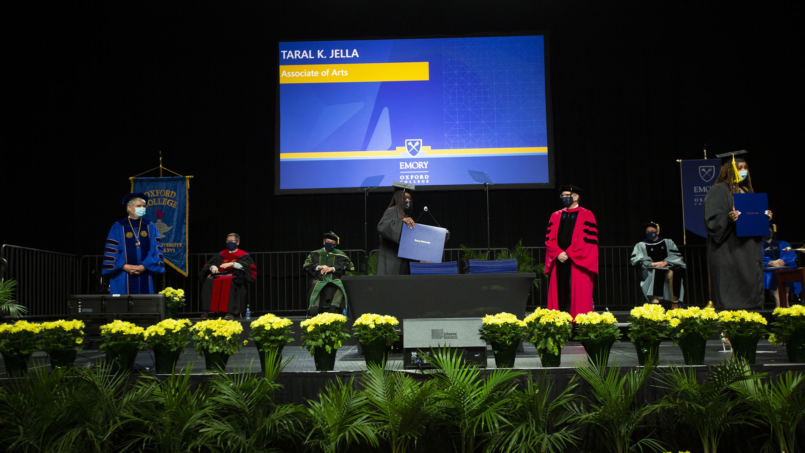 An Oxford graduate walks across the stage.