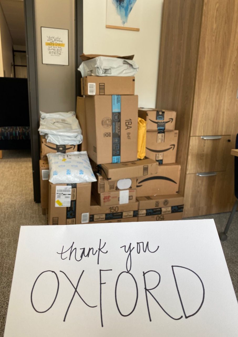 A card reading Thank You Oxford in front of collected supplies