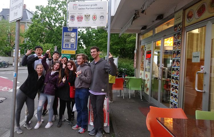 Students gather on a German street corner.