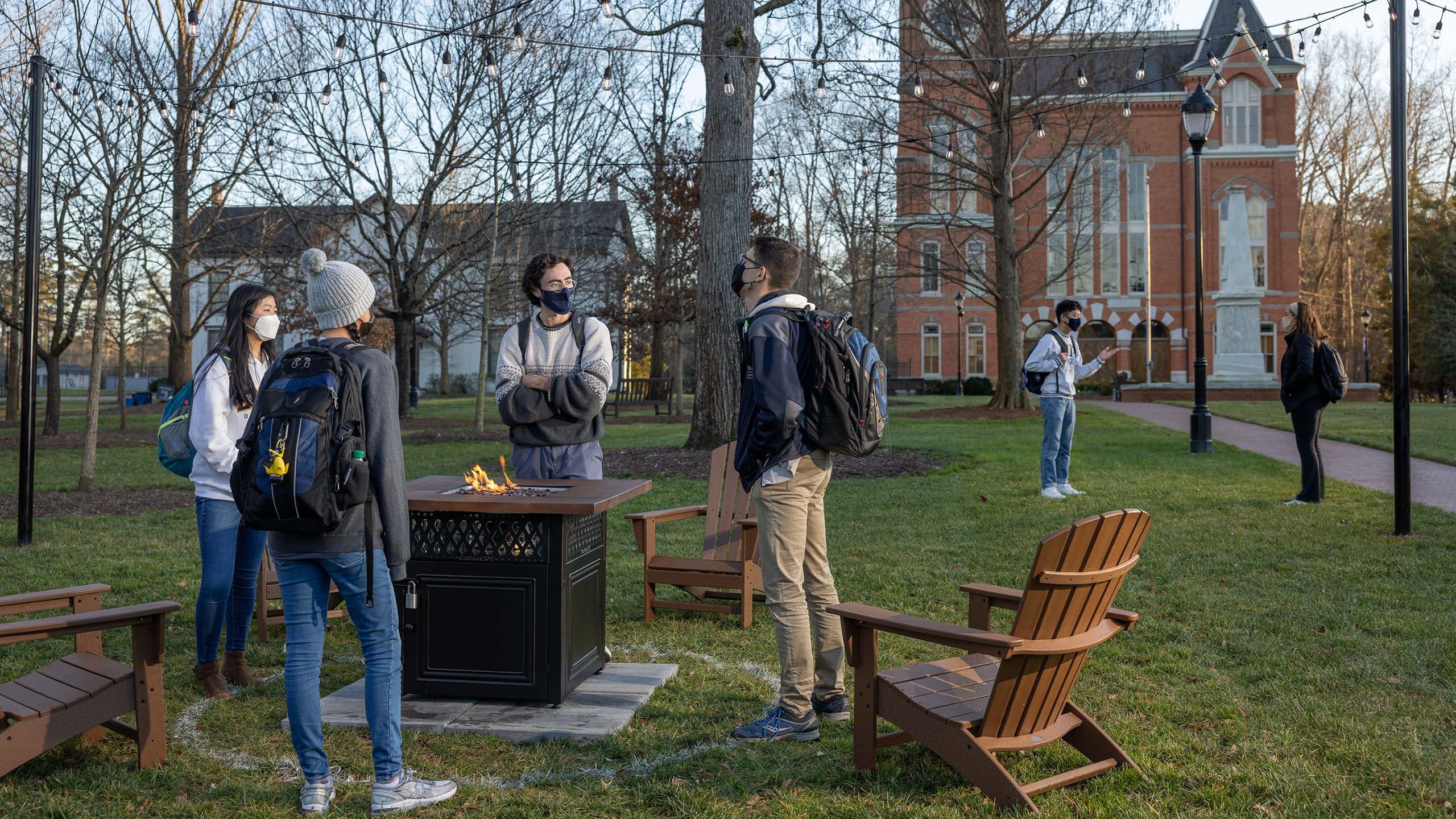 New gathering spaces around campus called hygge spots feature comfortable chairs surrounding fire pits.