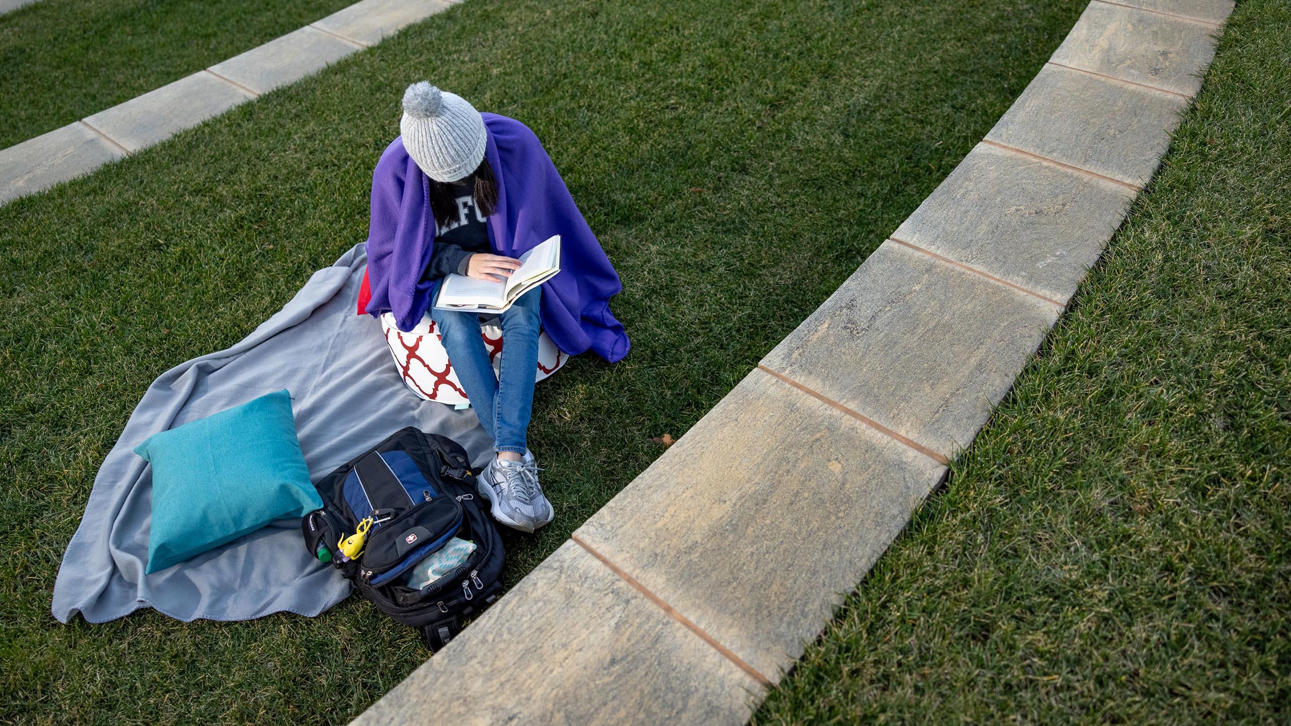 Cushions and blankets provide cozy outdoor spaces for studying.